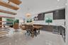 Open-concept kitchen and living area featuring a floating staircase with wood treads, high-gloss cabinetry, built-in wine refrigeration, large-format 