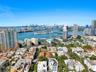 Aerial perspective featuring an urban skyline, harbor with deep-water access, multi-level residential structures, and coastal waterfront access