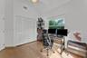 Vaulted ceilings, wood-finish flooring, and white louvered-door closet featuring a ceiling fan and natural lighting