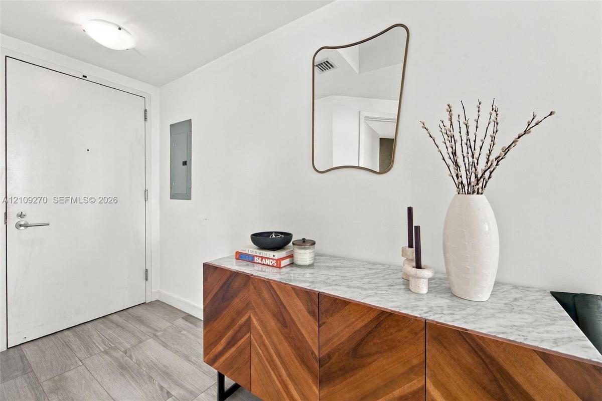 Entryway featuring neutral-tone ceramic tile flooring and a flush-mount ceiling fixture