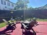 Rear exterior space featuring a paved patio area and a tall wood privacy fence