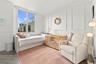 Interior space featuring wood-finish flooring, decorative wall molding, and a large window