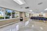 Open-concept interior featuring polished stone flooring, expansive floor-to-ceiling windows, and recessed ceiling lighting