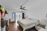 Wood-finish flooring, matte black ceiling fan with integrated lighting, and French doors