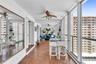 Enclosed balcony, floor-to-ceiling windows, full-wall mirrors, and dual ceiling fans
