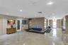 Lobby featuring polished stone floor tiling, stone-clad wall accents, recessed lighting, and metal elevator doors