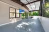 Screened patio featuring tile flooring, a skylight, exposed wood-beam ceiling, and sliding glass doors