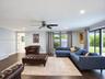 Spacious room featuring wood-finish tile flooring, recessed lighting, a ceiling fan, and large sliding glass doors