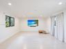 Bright interior space featuring wood-finish flooring, recessed lighting, and black-framed windows
