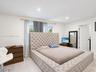 Neutral-toned wood-finish flooring, recessed lighting, and a multi-panel interior door