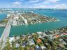 Aerial perspective of a coastal peninsula featuring extensive waterfront property lines, deep-water access, mature tropical vegetation, and proximity 