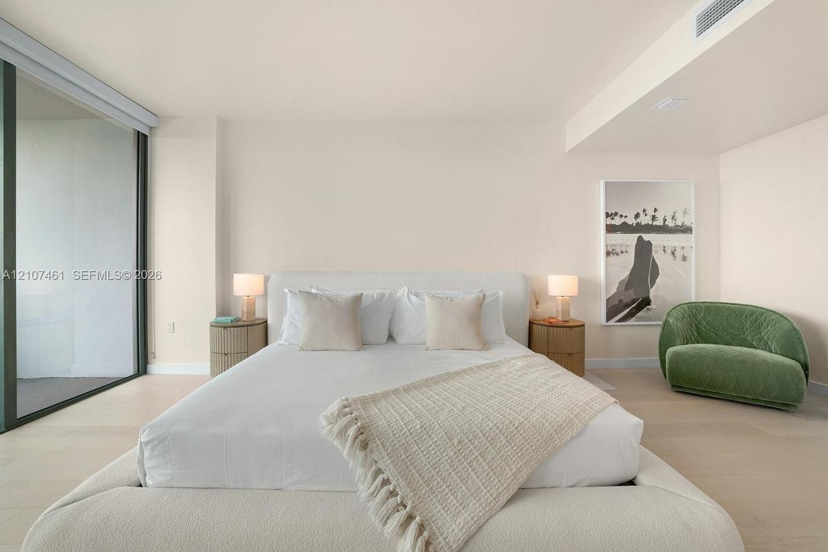 Full-height glass sliding door, neutral flooring, and recessed ceiling lighting