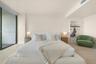 Full-height glass sliding door, neutral flooring, and recessed ceiling lighting