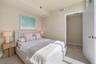 Neutral-toned wall finishes featuring light-finish wood-finish flooring and a minimalist door with brushed metal hardware