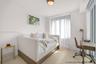 Light-toned wood-finish flooring, floor-to-ceiling windows, and brass-finish flush mount lighting