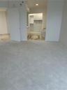 Carpeted room featuring a custom walk-in closet with built-in cabinetry, drawers, and shelving, stone flooring, and a soaking tub