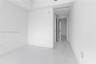 Neutral interior featuring high-gloss tile flooring, recessed ceiling lighting, and smooth-finish walls