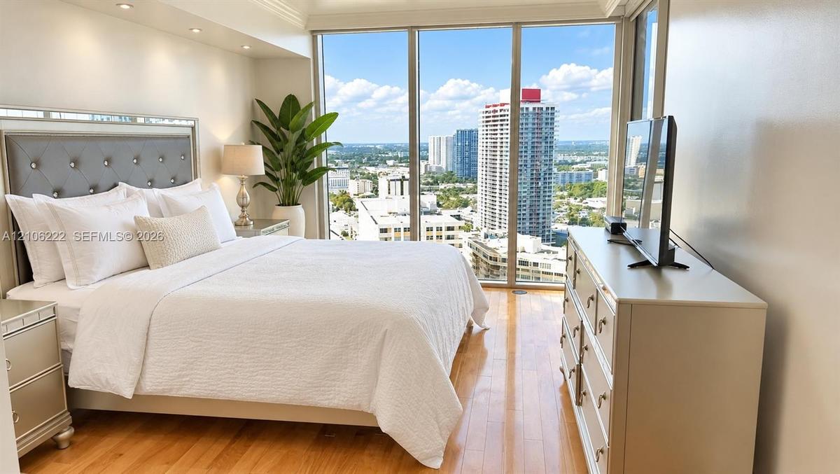 Floor-to-ceiling windows, wood-finish flooring, recessed lighting, and crown molding