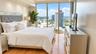 Floor-to-ceiling windows, wood-finish flooring, recessed lighting, and crown molding