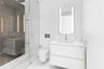 Floating white vanity with solid surface countertop, wall-mounted toilet, glass-enclosed shower featuring dark stone-finish tile, and integrated LED-l