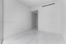 Minimalist interior space featuring polished light-toned stone flooring and dual-panel sliding closet doors