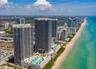 High-rise coastal property featuring direct oceanfront access, elevated swimming pools, expansive sun decks, and panoramic water horizons