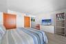 Neutral wall palette featuring wood-finish flooring and solid core wood doors