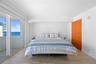 Wood-finish flooring, floor-to-ceiling sliding glass doors, recessed lighting, and a solid wood door