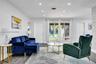Interior space featuring wood-finish flooring, recessed lighting, expansive multi-panel windows, and a textured stone-finish accent wall