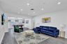 Open-concept interior featuring wood-finish flooring, recessed lighting, and horizontal window blinds