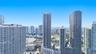 High-rise urban landscape featuring glass-facade residential towers, expansive city skyline, and multi-level architectural density