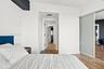 Sliding closet doors with frosted panels, wood-finish flooring, and recessed ceiling lighting