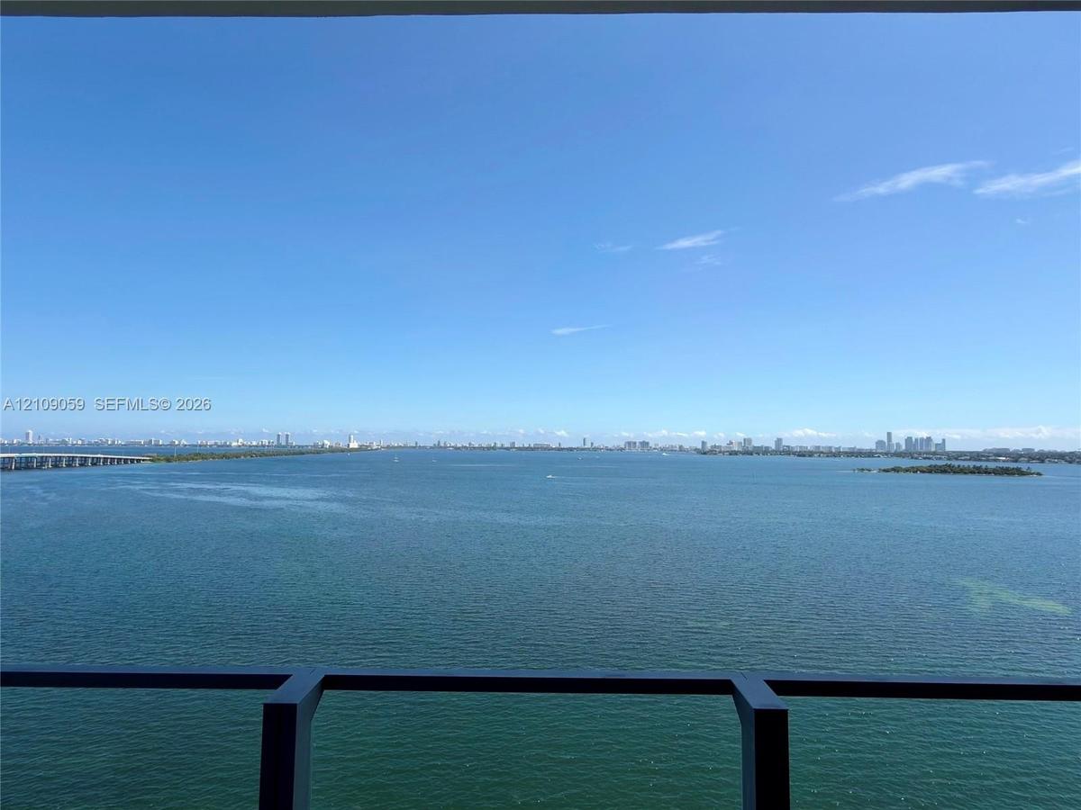 Elevated balcony featuring a dark metal railing with expansive, unobstructed water scenery