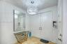 Foyer entry featuring double doors, stone tile flooring, and a spherical crystal pendant light fixture