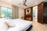 Room featuring natural stone flooring, floor-to-ceiling wood-finish paneling, louvered sliding glass doors, recessed lighting, and a modern metal ceil
