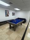 Large-format stone tile flooring and recessed panel ceiling lighting