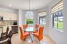 Kitchen area featuring flat-panel cabinetry, a built-in wine refrigerator, mosaic tile backsplash, recessed lighting, and a spherical crystal pendant 