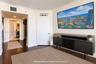 Interior space featuring dark wood-finish flooring, crown molding, and recessed lighting