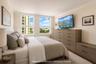 Neutral wall paint with crown molding and two large windows