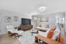 An inviting living area featuring elegant contemporary furnishings, abundant natural light, and a spacious layout designed for effortless entertaining