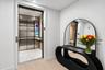 An elegant private elevator foyer welcomes you home with sophisticated architectural details and a striking designer console, setting the tone for lux