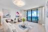 Sophisticated coastal living at its finest, featuring a beautifully appointed living room with modern designer furnishings and a warm, inviting atmosp