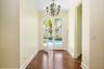 lovely front glass doors open to foyer and expanded living room. Fantastic courtyard pool views