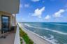 Covered balcony featuring metal railing and direct ocean exposure
