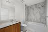 Secondary bathroom features a combination shower / tub
