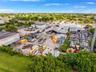 Expansive industrial lot featuring multiple commercial warehouse structures, extensive open-air storage space, and perimeter fencing