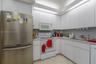 Kitchen featuring floor-to-ceiling white cabinetry, integrated recessed lighting, stainless steel refrigerator, white electric range with over-the-ran
