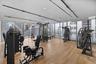 Fitness space featuring floor-to-ceiling windows, wood-finish flooring, recessed lighting, and track lighting