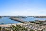 Elevated perspective featuring expansive water frontage, a multi-lane causeway, and a skyline backdrop
