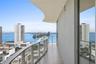 Curved balcony featuring tile flooring and a glass panel railing
